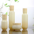 High-grade Cosmetic Gradient green glass bottles/jars with wood grain cap